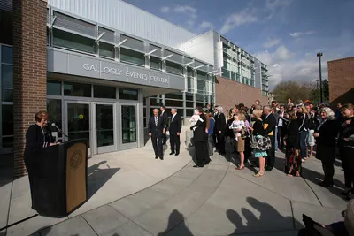 Opening ceremony with a crowd of people in front of Gallogly Events Center 